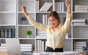 Person celebrating success after building Good Habits.